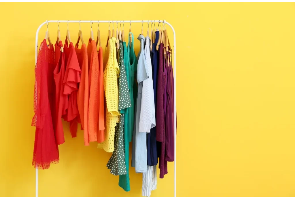 Picture of a hanging cothes rack holding multi-colored women's clothing