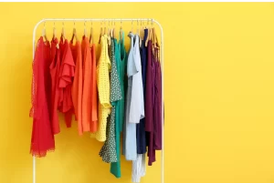 Picture of a hanging cothes rack holding multi-colored women's clothing